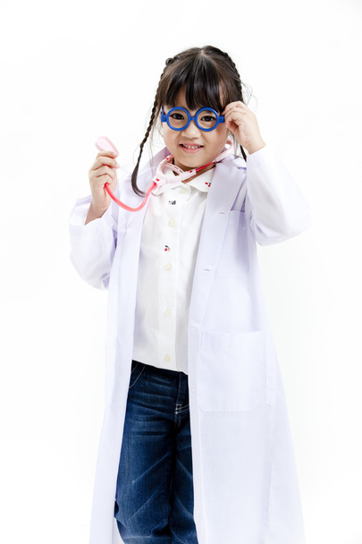 A young asian girl having fun playing dress up as a doctor - Foto, immagini