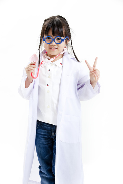 A young asian girl having fun playing dress up as a doctor - Foto, imagen