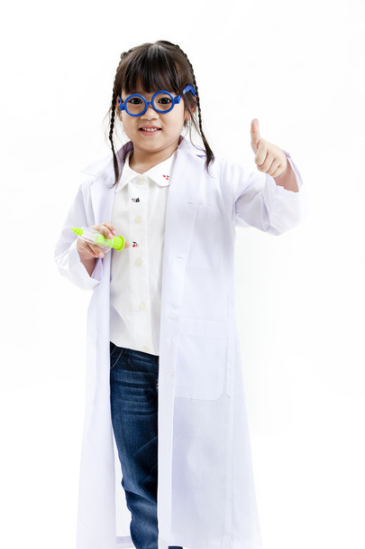 A young asian girl having fun playing dress up as a doctor - Fotó, kép