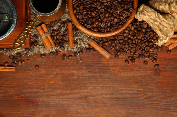 Coffee beans, metal turk and coffee mill on wooden background with copy space - Valokuva, kuva