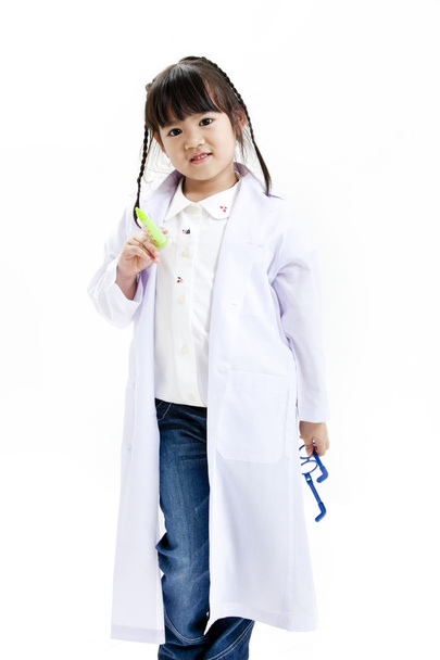A young asian girl having fun playing dress up as a doctor - Foto, afbeelding