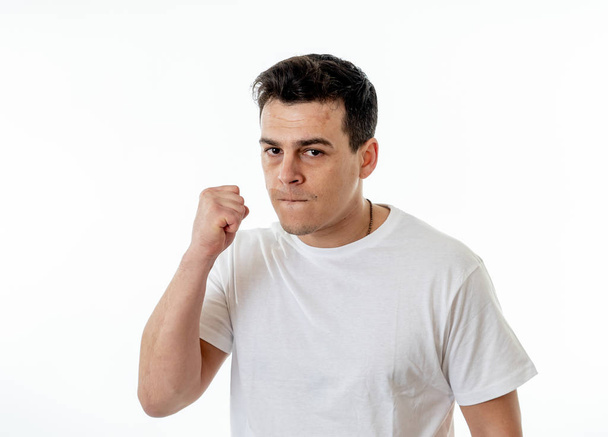 Close up portrait of an attractive young caucasian man with angry face looking furious and crazy showing teeth and fist isolated on white background. In People, Human facial expressions and emotions. - Photo, image