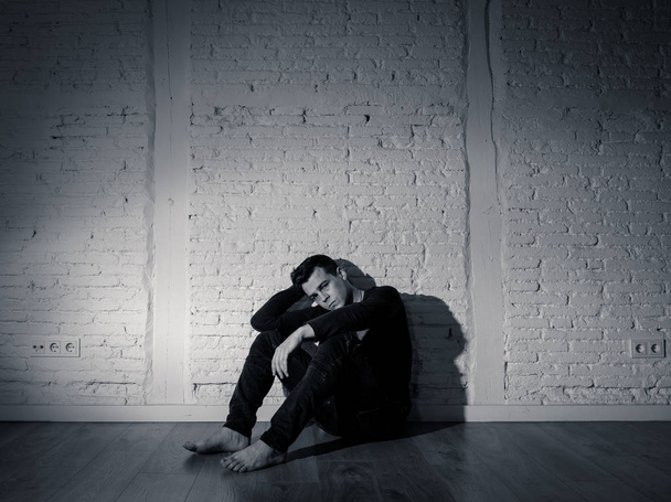 Portrait of sad depressed young man crying devastated feeling hurt suffering Depression in People, Sadness, Emotional pain, Loneliness and Heartbroken concept with copy space and dark mood light. - Photo, image