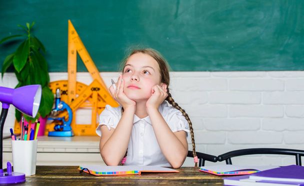 thoughtful child. small child in classroom. digital age with modern technology. small girl study with in school. Formal informal and nonformal education. future success is studying. back to school - Фото, изображение