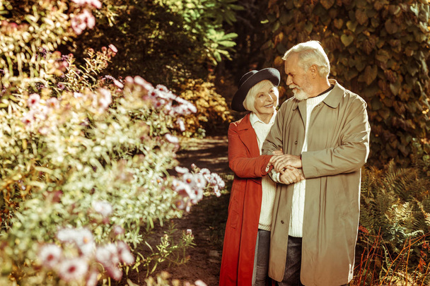 Happy elderly couple taking a stroll together. - 写真・画像