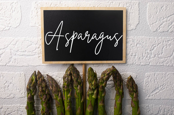 Green asparagus, healthy seasonal vegetables on a white background. - Foto, afbeelding