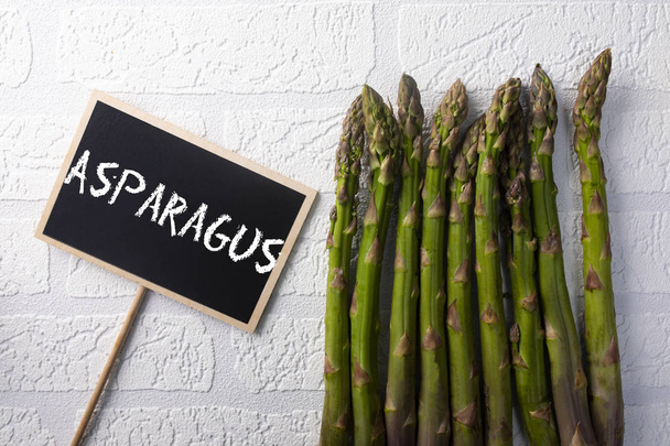 Asparagus, fresh seasonal vegetables on a white background. - Zdjęcie, obraz