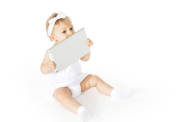 little girl all in white with a tablet - Φωτογραφία, εικόνα
