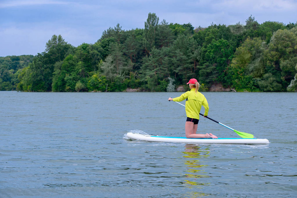 SUP Stand up paddle board concept - Pretty, young woman paddle b - Photo, Image