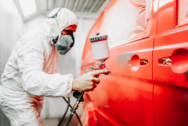 Close up details of mechanic worker, painting a red car - Fotoğraf, Görsel