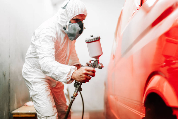 close up details of industrial worker, mechanic engineer using a paint gun and painting a car - Fotoğraf, Görsel