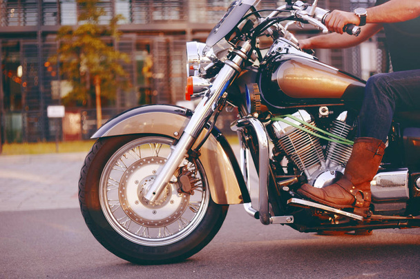 Motociclista montando una motocicleta. Vista inferior de las piernas en cuero
 - Foto, imagen
