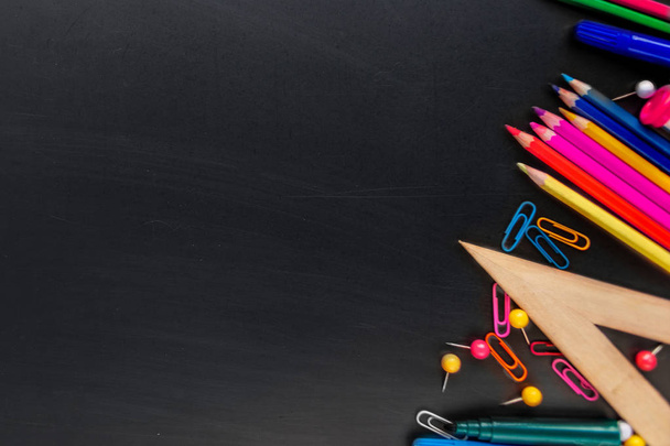 School supplies on black board background with Stationery. Back  - Foto, imagen