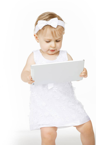 little girl all in white with a tablet - Fotó, kép
