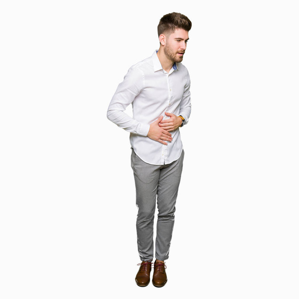 Young handsome business man with hand on stomach because nausea, painful disease feeling unwell. Ache concept. - Fotoğraf, Görsel