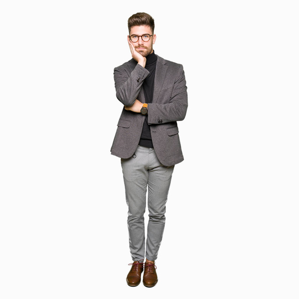 Young handsome business man wearing glasses thinking looking tired and bored with depression problems with crossed arms. - Photo, Image