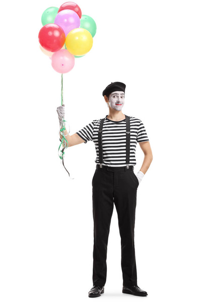 Pantomime man standing with a bunch of balloons - Φωτογραφία, εικόνα