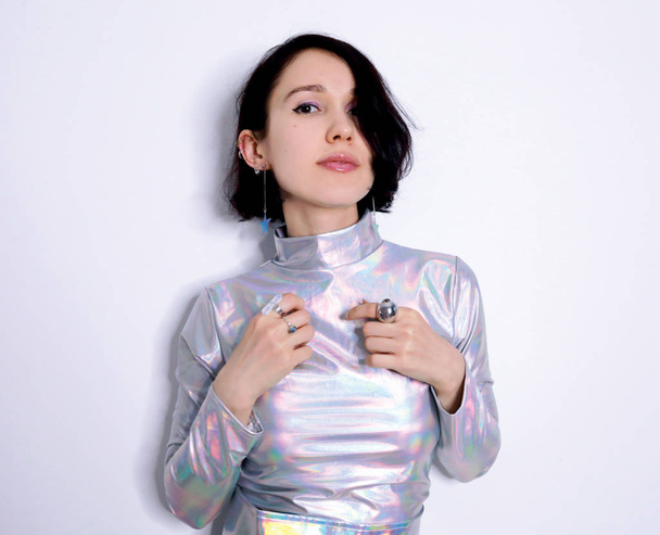beautiful girl in trendy holographic space suit - 写真・画像