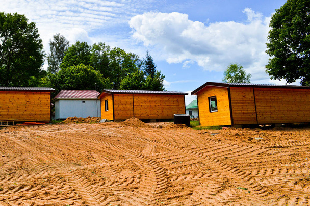 Construction de petites maisons préfabriquées préfabriquées à ossature de bois jaune en éco-maison modulaire de banlieue à croissance rapide, bâtiments, chalets. Construction industrielle
 - Photo, image