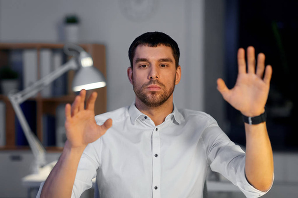 businessman using gestures at night office - Foto, immagini