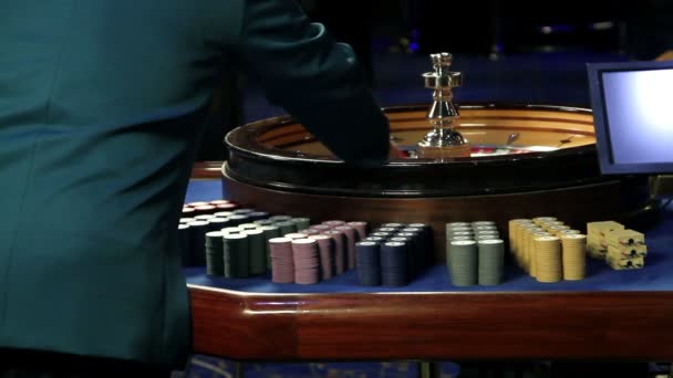 Playing roulette shot from behind of casino worker - Footage, Video