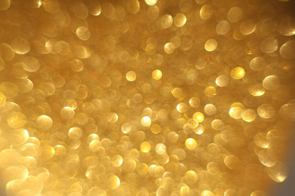 Golden glitter christmas abstract bokeh background. Blurred sparkles backdrop - Photo, Image