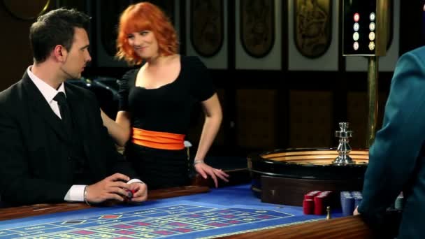 νεαρό ζευγάρι παίζει roluette στο καζίνο - Πλάνα, βίντεο