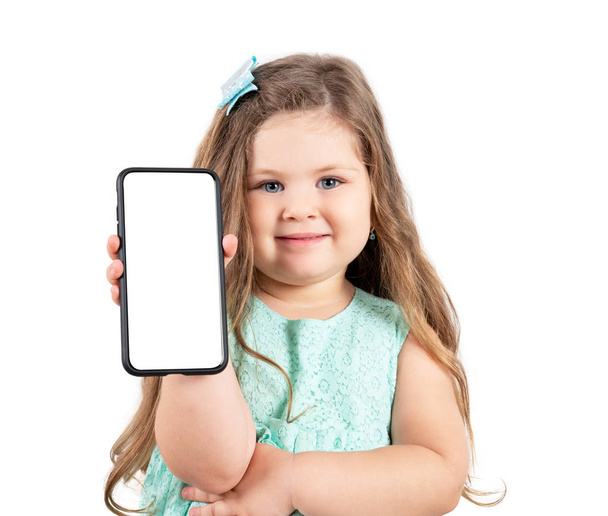 little girl holding a smartphone with a white screen - Φωτογραφία, εικόνα