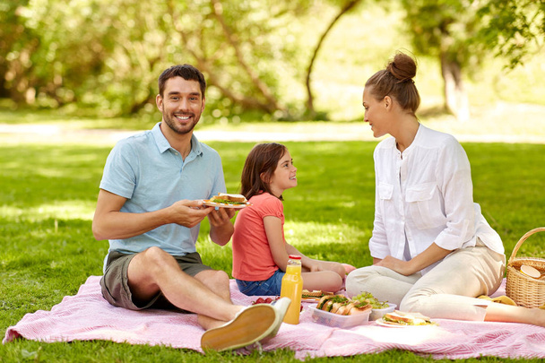 happy family having picnic at summer park - 写真・画像