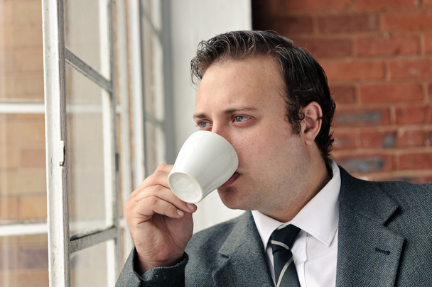 Suit man drinks coffee and thinks - Foto, Imagem