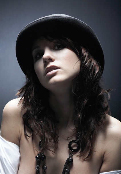 Beautiful young woman wearing black hat - Fotoğraf, Görsel