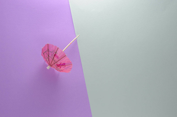 Summer umbrellas for cocktails on a purple and blue background - Фото, изображение