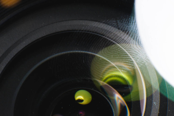 Fingerprint macro on a lens in natural light. Fingerprint scanning, biometrics and security concept. - Photo, Image
