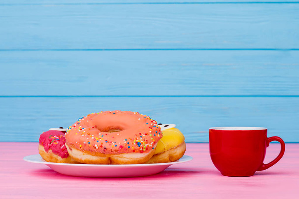 Plate with donuts and cup of coffee. - Foto, imagen