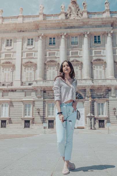 Beautiful tourist woman posing near Royal Palace of Madrid, Spai - Фото, изображение
