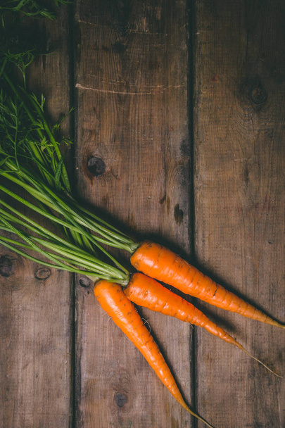 Fresh tasty carrots on a wooden rustic table. Healthy food. Vege - Φωτογραφία, εικόνα