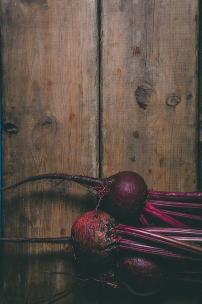 A bunch of fresh beets on a wooden rustic table. Copy space. Hea - Fotoğraf, Görsel