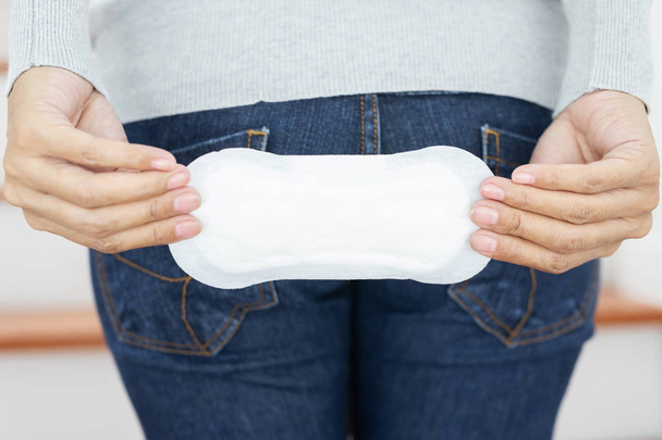 Female Hygiene. Close Up Young woman holding a Clean Period slim sanitary napkin pad. Reports daily menstrual period day use on every month. Feminine Intimate Product. health care concept. - Photo, Image
