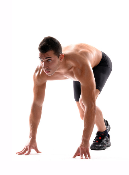 Healthy and fitness man on running start position on white background. - Photo, image