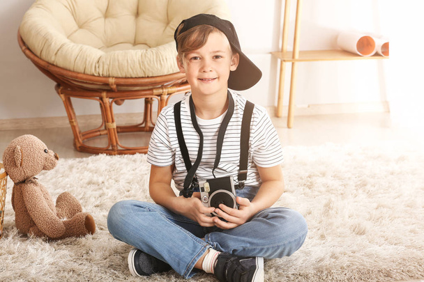 Cute little photographer with professional camera at home - Foto, imagen