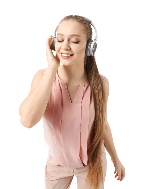 Beautiful young woman listening to music on white background - Fotoğraf, Görsel