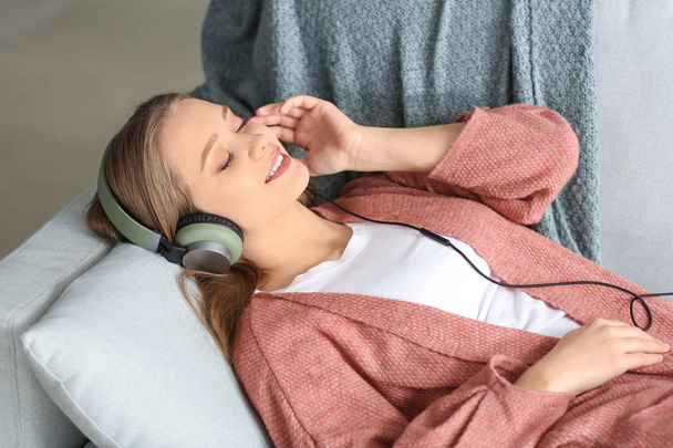Beautiful young woman listening to music at home - Photo, Image