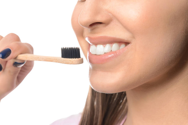 Woman with toothbrush on white background, closeup. Concept of dental hygiene - Φωτογραφία, εικόνα