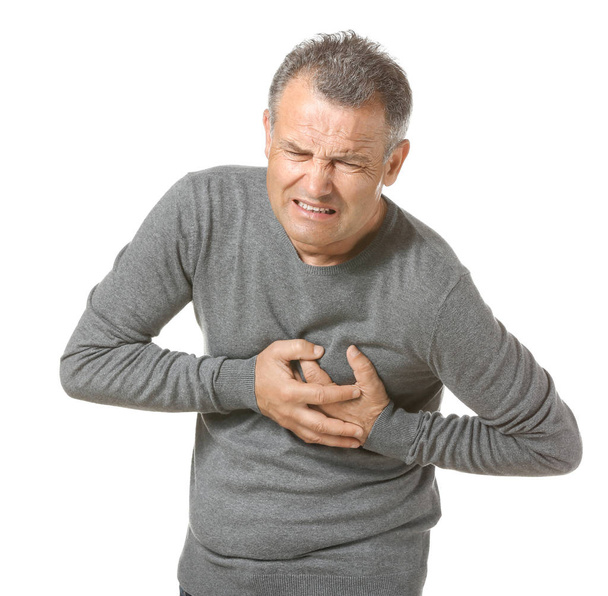 Mature man suffering from heart attack on white background - Photo, image