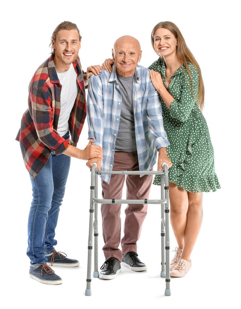 Elderly man with relatives on white background - Фото, изображение