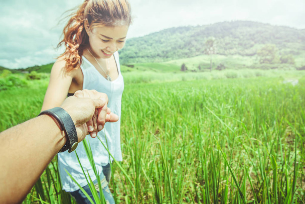Lover Couple women and men Asians travel relax in the holiday. Lovers walk hand in hand on grassland. - Photo, Image