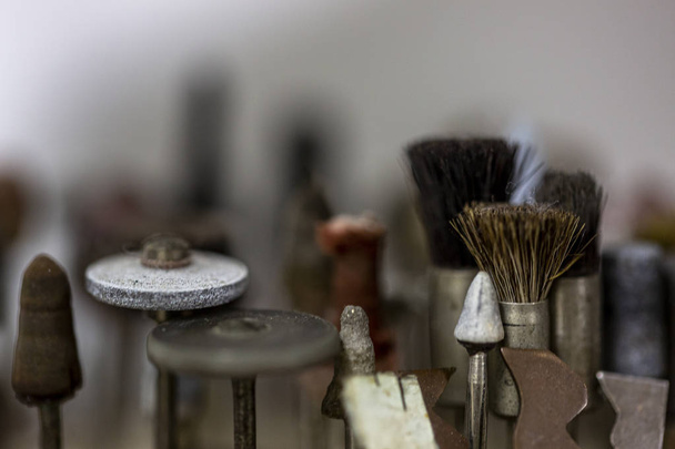 Close up of very small brushes that can be mechanically driven by a machine to cultivate and polish precious metals such as gold and silver to sand down and polish jewellery - Photo, Image