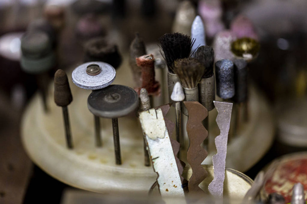 Close up of a group of very small brushes that can be mechanically rotated by a machine to cultivate and polish precious metals such as gold and silver to sand down and polish jewellery - Photo, Image