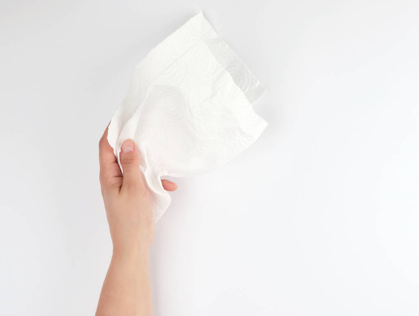 female hand holding a clean white paper napkin  - Zdjęcie, obraz