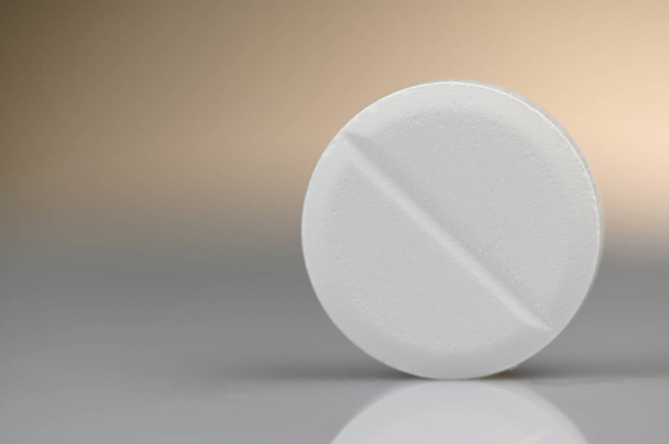 White pill rotate on a black background, Macro shot - Fotó, kép